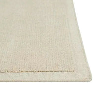 Close-up of GlobeWest Bower Frame Rug in cloud color, hand-woven 100% wool with a simple, layered texture design