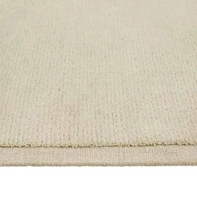 Close-up of GlobeWest Bower Frame Rug in Cloud color with hand-woven wool texture