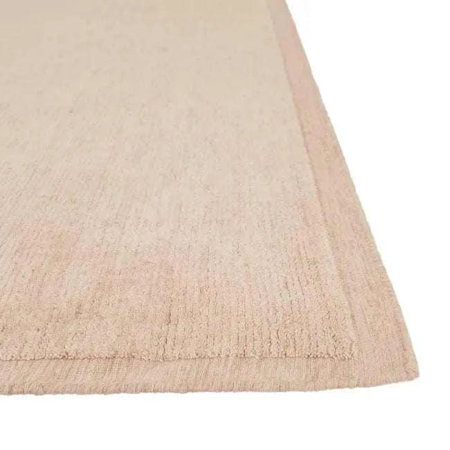 GlobeWest Bower Frame Rug in rose color, hand-woven wool with simple framed design.