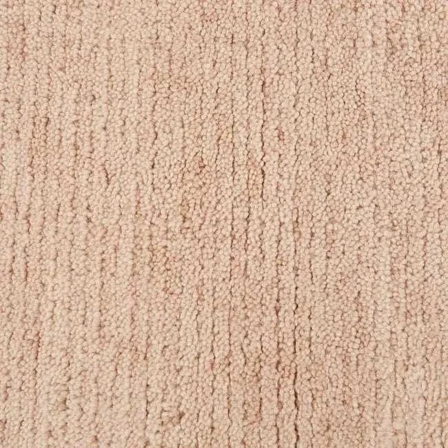 Close-up of the soft, hand-woven GlobeWest Bower Frame Rug in rose-colored 100% wool texture