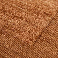 Close-up of GlobeWest Bower Frame Rug in rust color showing handwoven wool texture and framed design