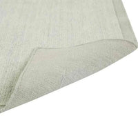 GlobeWest Bower Frame Rug in seafoam color, hand-woven 100% wool with a simple textured design and folded corner showing backing.