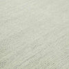 Close-up of hand-woven GlobeWest Bower Frame Wool rug in seafoam color with textured surface