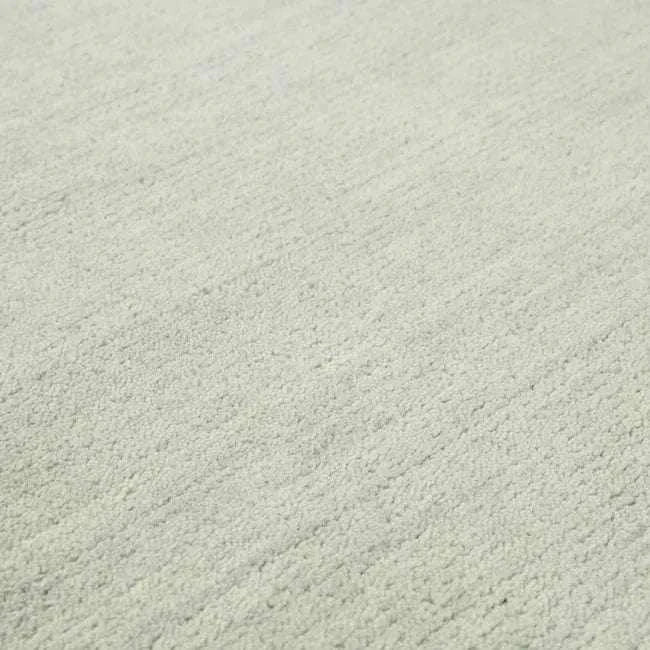 Close-up of hand-woven GlobeWest Bower Frame Wool rug in seafoam color with textured surface