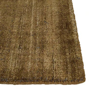 Close-up of GlobeWest Tepih Dune Rug in olive wool blend with subtle pattern and hand-woven texture