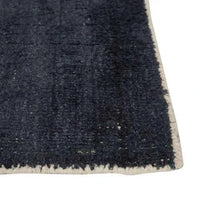 Close-up of GlobeWest Tepih Neptune Rug in midnight color, hand-woven wool blend with subtle rustic texture