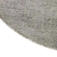 Close-up of GlobeWest Tepih Neptune round dove grey hand-woven wool, silk, and cotton rug edge