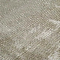 Close-up of GlobeWest Tepih Tide Rug in oyster color with hand-woven viscose and wool ripple design.