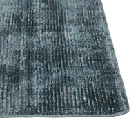 Close-up of GlobeWest Tepih Tide Rug in marine color with hand-woven viscose and wool texture.
