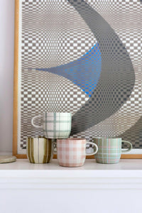 Set of four Robert Gordon hand-painted ceramic mugs featuring tartan, stripes, and gingham designs in soft pastel colors.