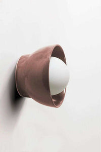 norsu x Robert Gordon Bowl Sconce Light in dusty rose ceramic with white globe mounted on wall