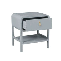 Charles Bedside in dusty blue with soft waterfall edges, one drawer with leather handle, and suspended shelf for minimalist storage.