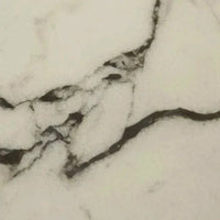 Close-up of GlobeWest Oberon Crescent bedside table's Carrara marble top with white background and natural grey veining