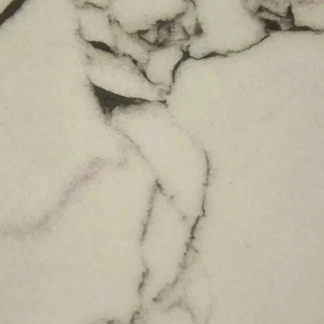 Close-up of GlobeWest Oberon Crescent bedside table with white Carrara marble top featuring natural veining