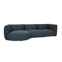 Dark teal Slipper modular sofa with three curved pieces, inspired by 1970s lounge style.
