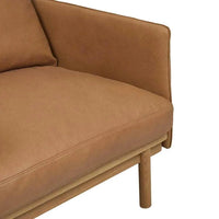 Close-up of Globe West Tolv Pensive Occasional Chair in camel with plush cushions and light oak legs