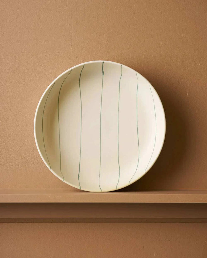 Coastal Junction 28cm cream salad bowl with green vertical stripes on beige background