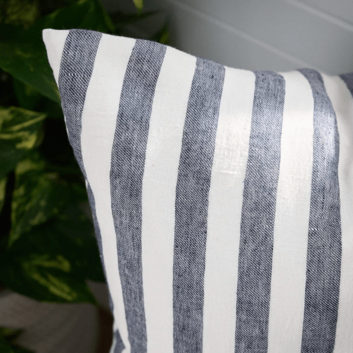Eadie Lifestyle Santi Linen cushion with white and navy wide stripes, made from 100% linen, featuring bold yarn-dyed fabric and plump feather insert.