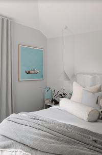 Greg Mount Fine Art Print "You Can't Stop The Spring" featuring a vintage car on a pastel blue background in a modern minimal bedroom setting.