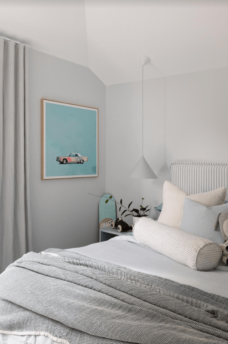 Greg Mount Fine Art Print "You Can't Stop The Spring" featuring a vintage car on a pastel blue background in a modern minimal bedroom setting.