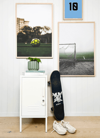 Customizable sports-themed wall art prints with choice of number and color, displayed in a modern room setting with skateboard and sneakers.
