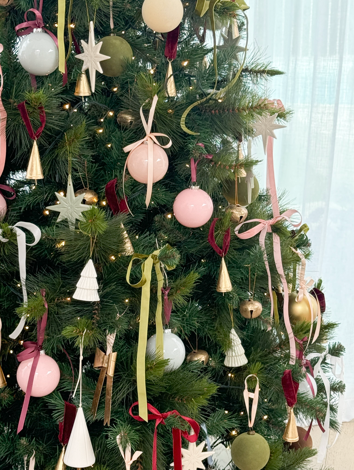 Christmas tree decorated with norsu STUDIO Premium Plush Velvet Ribbon bows in various colours and festive ornaments