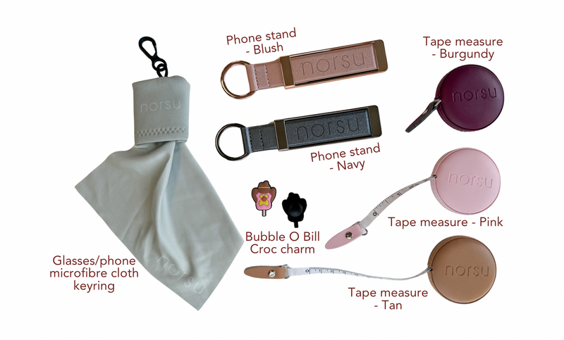 norsu STUD branded phone stands, tape measures, bubble croc charms, and microfiber cloth keyring set