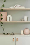 minimalist styled shelves with decorative objects and soft pastel accents
