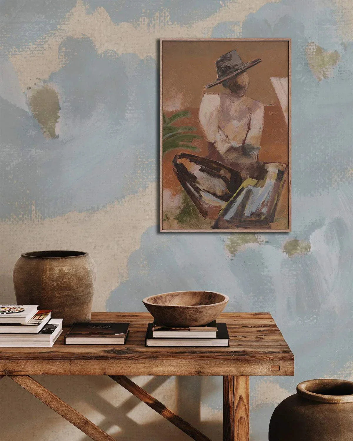 Marcia Priestley Limited Edition Traveller 2 fine art canvas print in floating oak frame displayed above rustic wooden table with pottery and books.