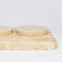 Beige CoTheory Travertine Footed Letter Tray with smooth rounded edges and raised circular feet