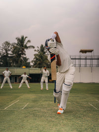 The Batsman cricket print by norsu – batsman in cricket whites playing a forward defensive shot with fielders behind
