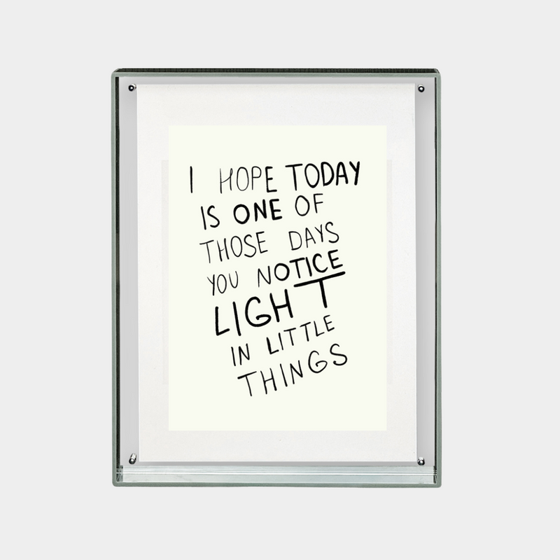 framed digital print with inspirational quote about noticing light in little things in black text on white background