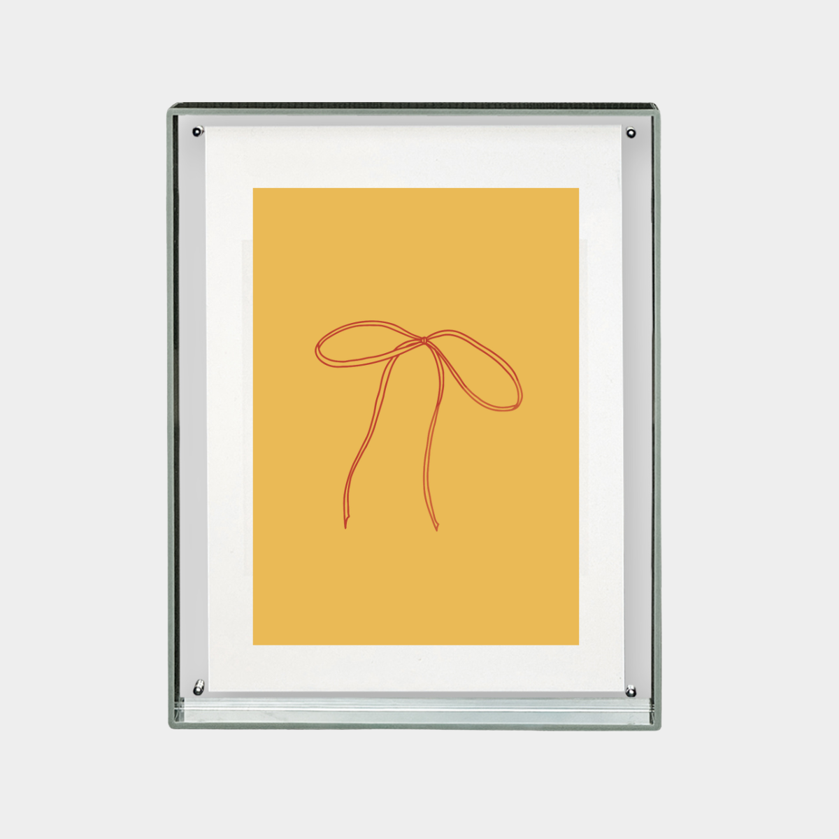 minimalist digital print of red ribbon bow on mustard yellow background in a clear frame