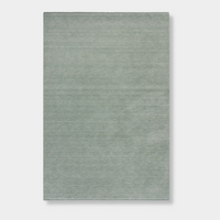 Baya Sandringham Floor Rug in aquamarine with a dense, hand-knotted wool pile and delicate fringed edges