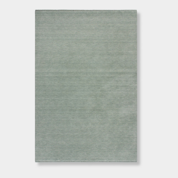 Baya Sandringham Floor Rug in aquamarine with a dense, hand-knotted wool pile and delicate fringed edges