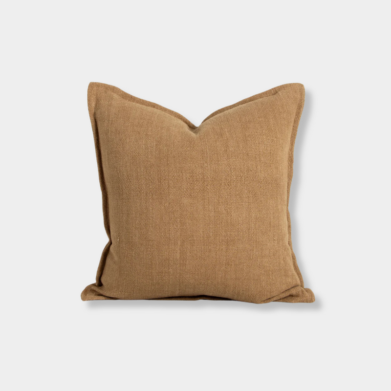 Baya Flaxmill Cushion in fenugreek color with 100% linen heavyweight weave, flange edge, and plush feather insert, measuring 50x50 cm.