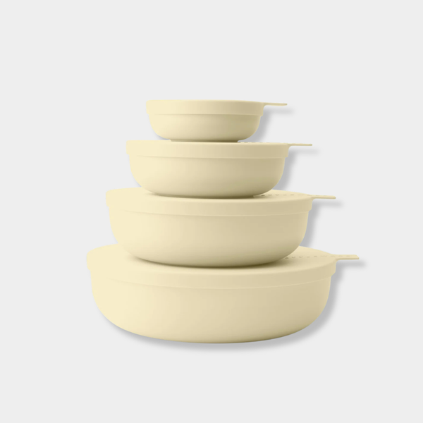 Set of four cream-colored Styleware nesting bowls with snap-tight lids in various sizes for versatile food storage and serving