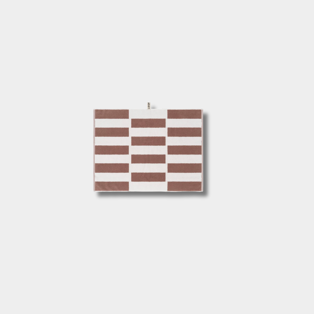 Loop Home Bath Mat in coffee and ivory with striped jacquard weave design on white background
