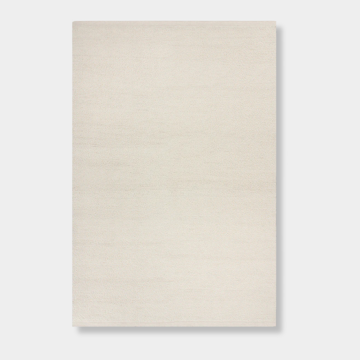 Baya Clifton Floor Rug in ivory, handcrafted 100% New Zealand wool with hand-knotted loop pile and flat edge finish.