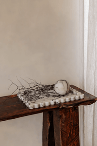 Palazzo Scalloped Marble Bar Tray large scalloped white and gray marble tray on wooden surface with decorative stone and branches