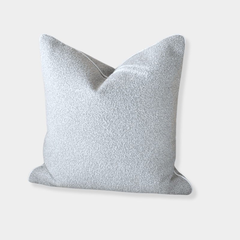 norsu Studio Cushion in powder blue boucle fabric with white leather piping, handcrafted luxury cushion from Melbourne, available in various sizes