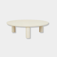 GlobeWest Seb Round Coffee Table with rope-colored claylime finish and three chubby pillar legs, modern low-profile design