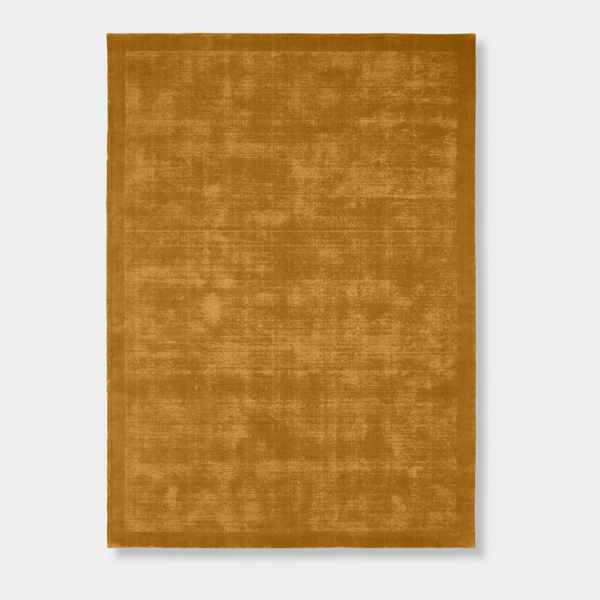 Hand-loomed Tait Rug in vibrant turmeric color with textured tip-sheared finish.