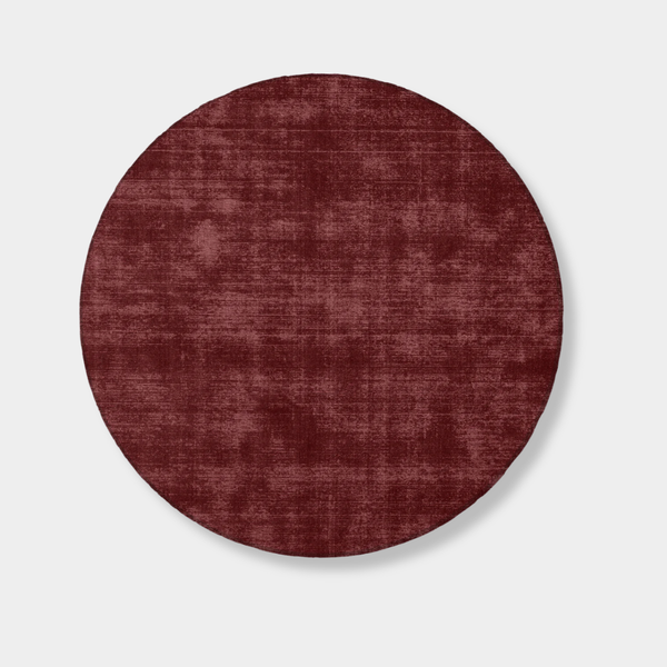 Round Tait Rug in dark cherry red, hand-loomed New Zealand wool with textured finish