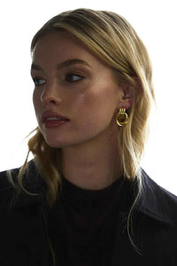 Woman wearing gold Zafino Poppy small hoop earrings with elegant design.