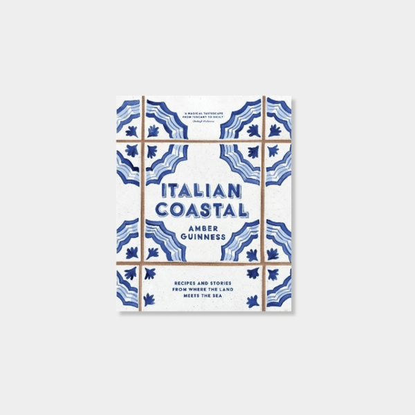 Italian Coastal cookbook by Amber Guinness with blue and white tile design cover featuring recipes and stories from the Mediterranean coast