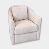 norsu Studio Swivel Chair in blush boucle fabric with feather-filled cushion and curved armrests