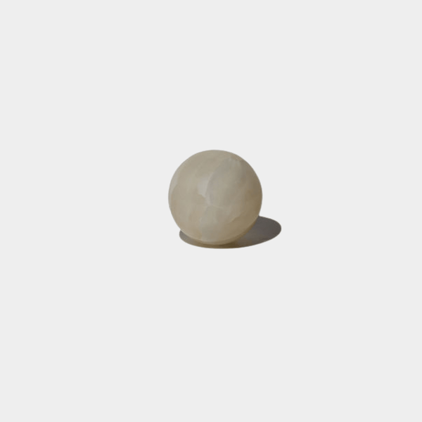 CoTheory Orbit Table Sculpture small white onyx sphere on white background