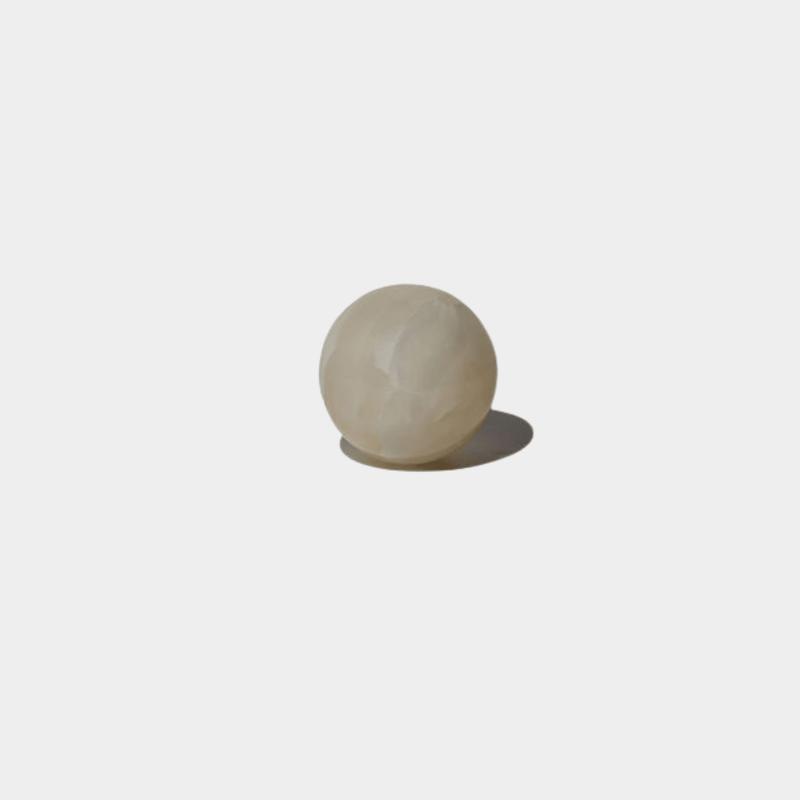 CoTheory Orbit Table Sculpture small white onyx sphere on white background