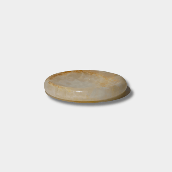 CoTheory Onyx Tray Solstice small white onyx round sculpted tray with natural stone variations and felt pads